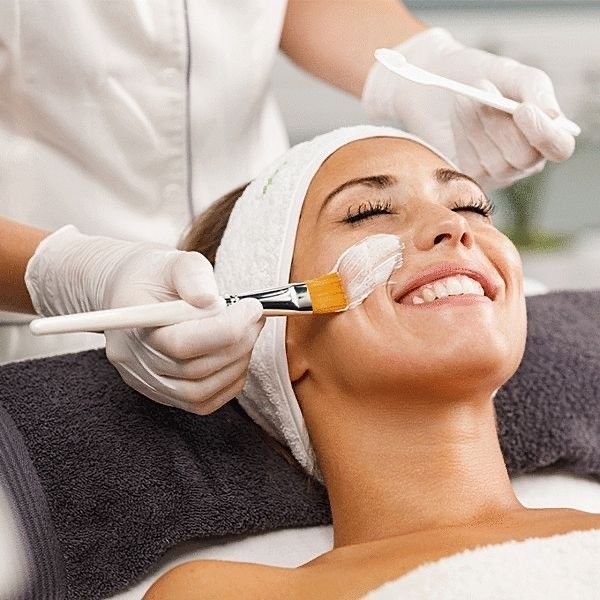 Client receiving a relaxing facial treatment at Hair by Naila salon in Mississauga.